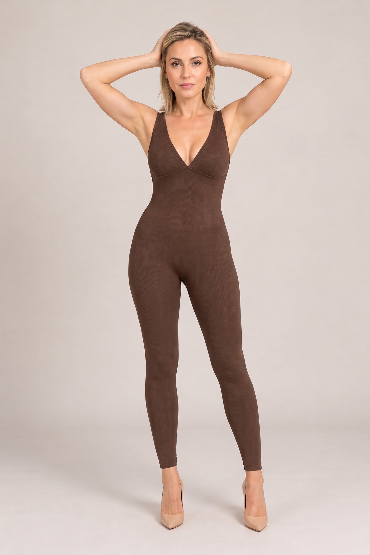 Deep-V Ribbed Jumpsuit in Brown, arms raised