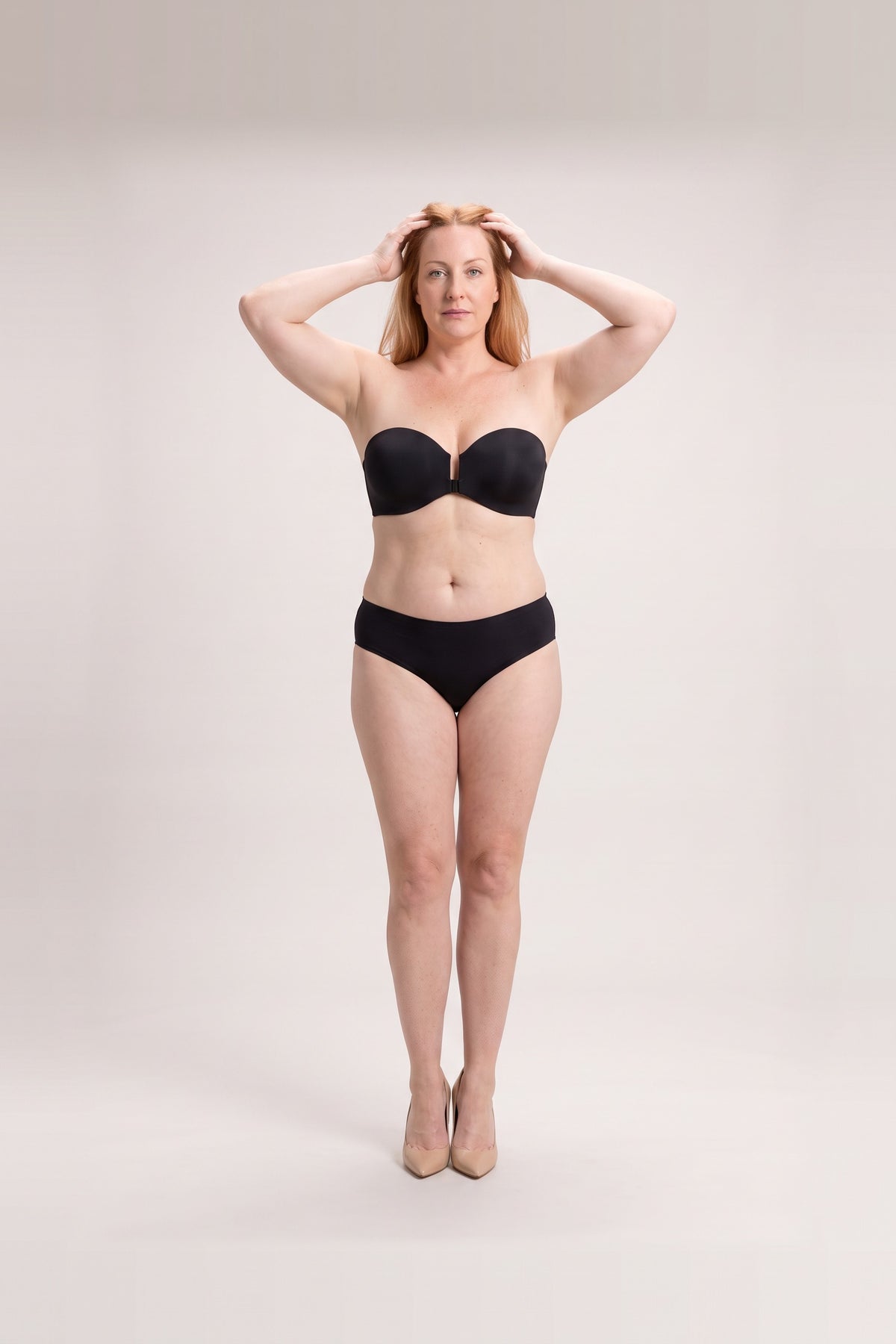Strapless Front-Clasp Bra in Black, arms raised