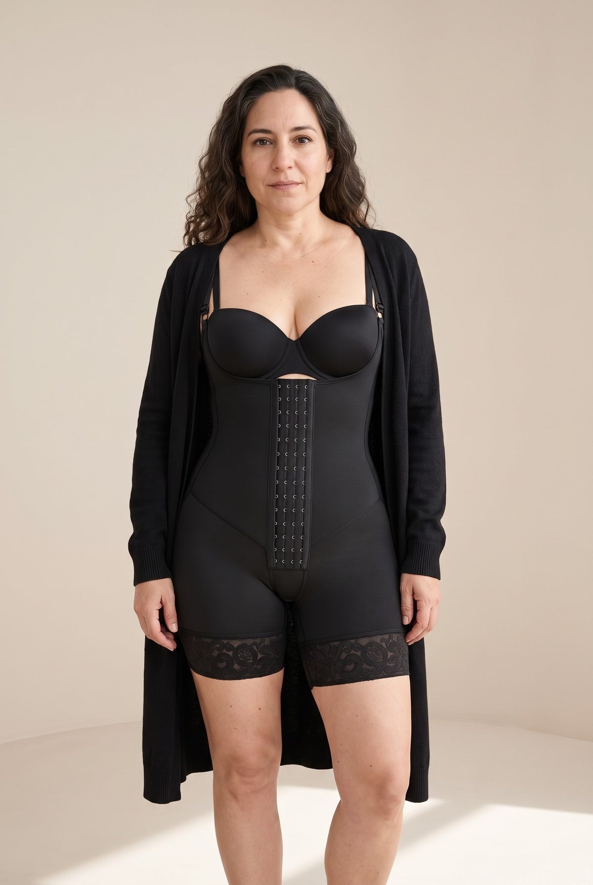 Hook-Front Bodysuit in Onyx with a black bra and an open cardigan