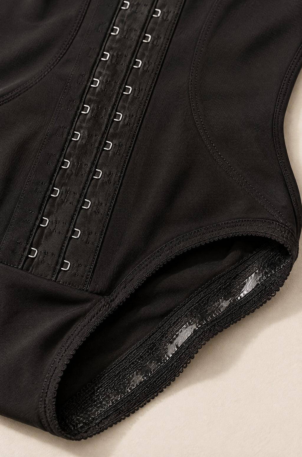 Close-up of the hook-and-eye front and the lace leg band