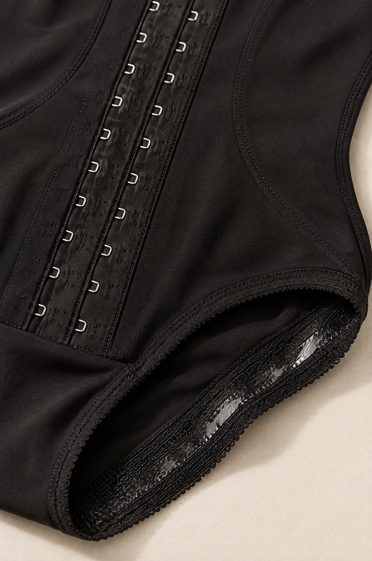 Close-up of the hook-and-eye front and the lace leg band
