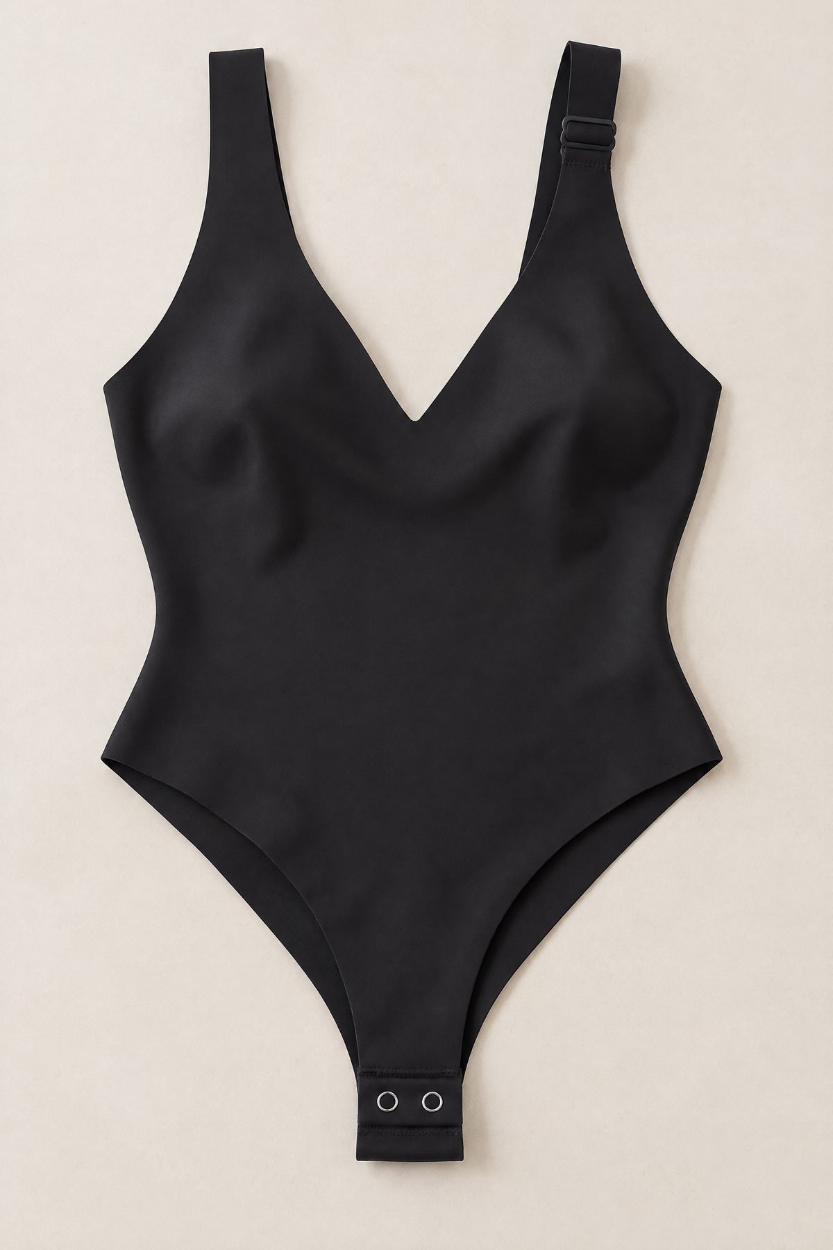 Plunge Thong Bodysuit in Black, laid flat with the snap gusset
